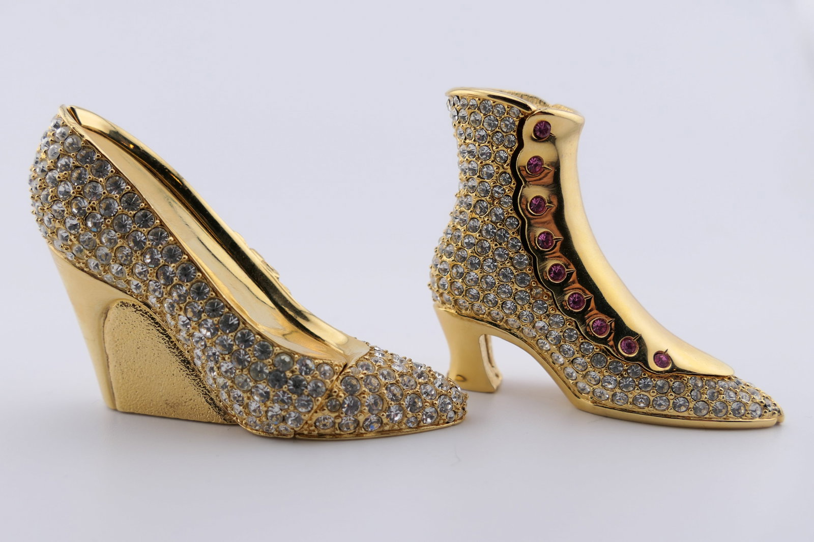 Two Estee Lauder Solid Perfume Compacts: Two Estee Lauder solid perfume compacts in the shape of heels, embellished with glass rhinestones. Both contain solid perfume, one of which is in the "White Linen" scent. Good condition, with perfume
