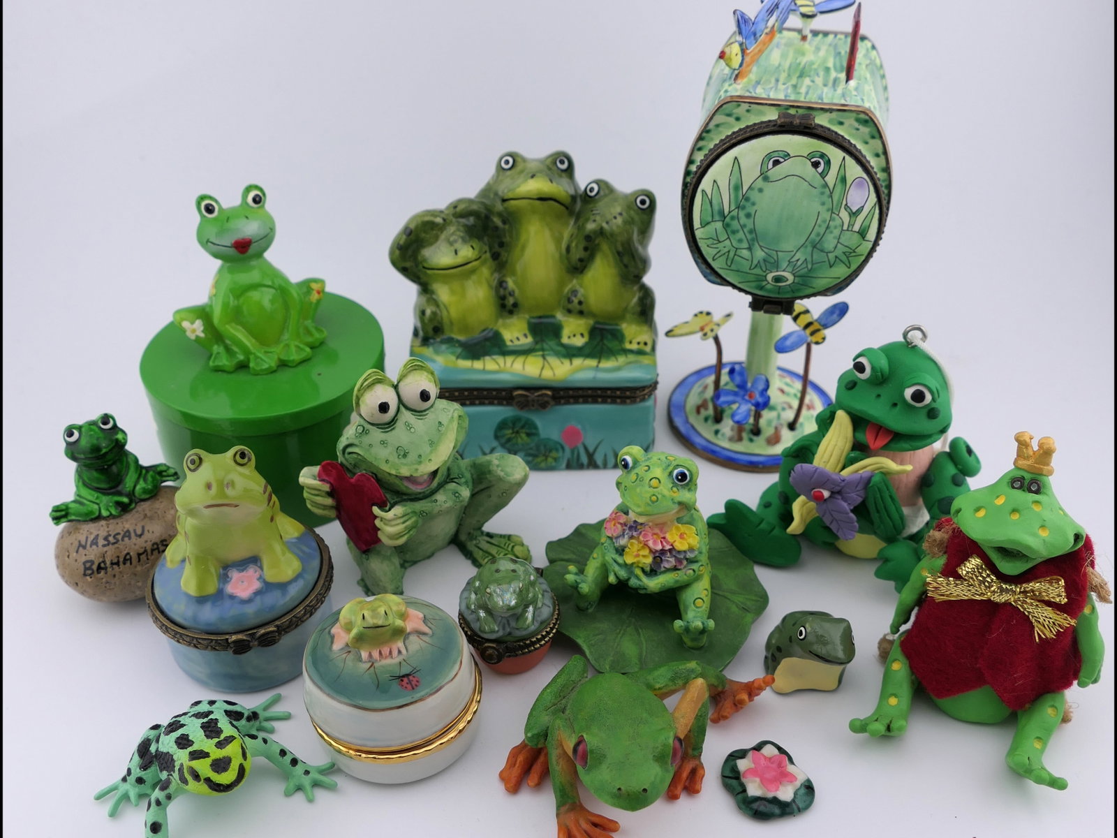 Frog Accent Pieces: Collection of frog themed accent pieces including an enameled frog swamp mailbox stamp dispenser by Kelvin Chen (2001), Russ Berrie & Co. figurines, Midwest of Cannon Falls box, and several frog