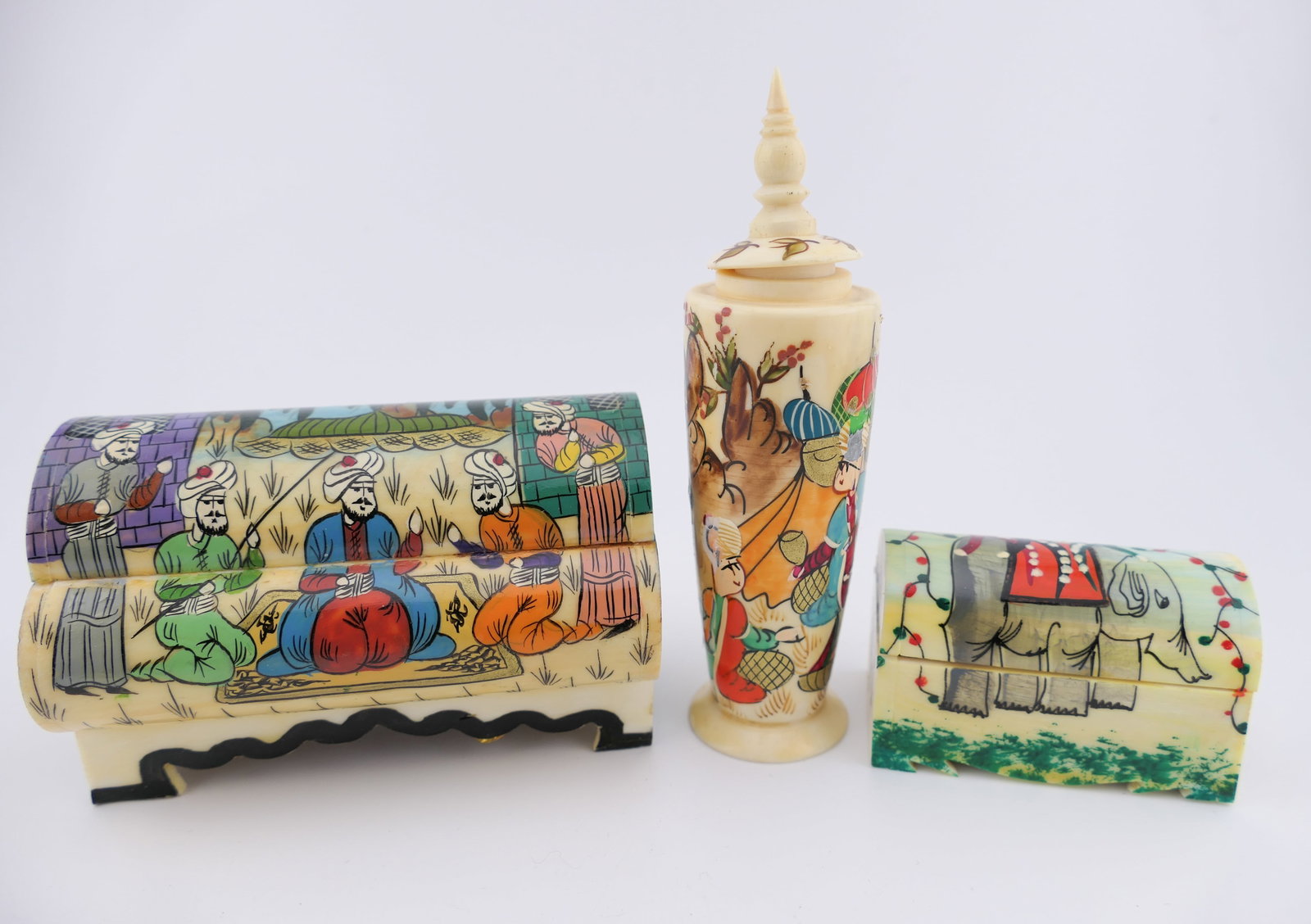 Hand Painted Bone Trinket Boxes: Three hand painted bone trinket boxes, believed to be Turkish or Persian made camel bone boxes, featuring floral and landscape motifs. The tall bottle is a perfume bottle with a dip stick attached to