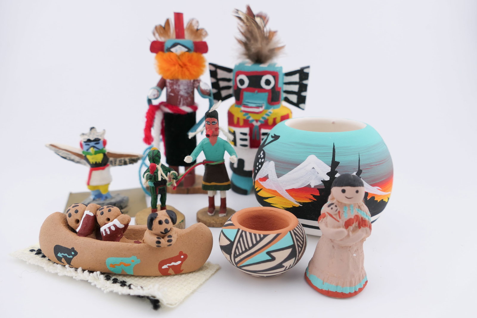 Native American Handmade Folk Art: Hand crafted folk art pieces by Native American artists such as a Warrior Kachina doll titled "Hopi" by G. Pooley, a Chasing Star miniature kachina doll, a doll titled "Navaho Maiden" marked RRZ, a