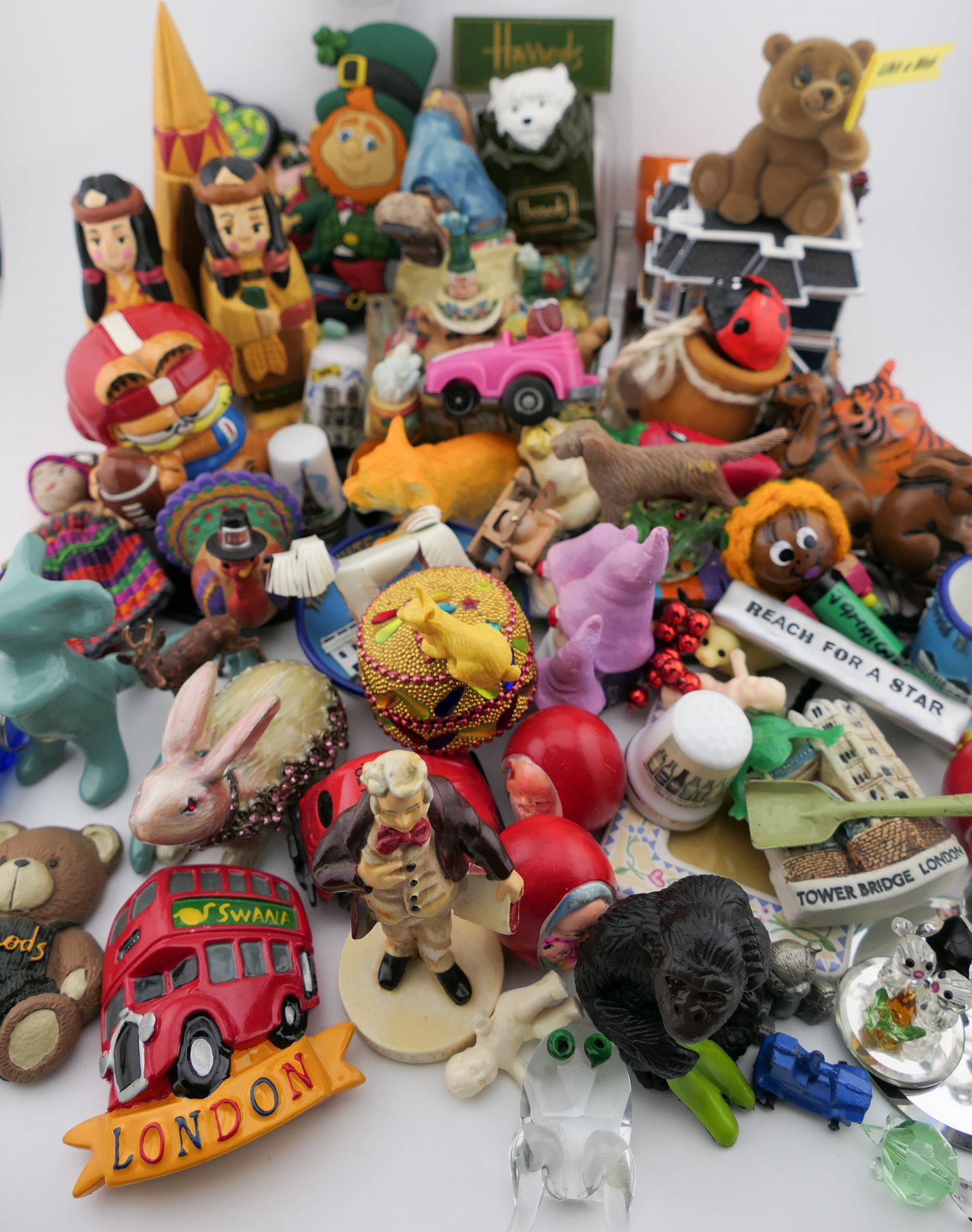 Assorted Trinkets and Souvenirs: Large assortment of trinkets and souvenirs including a 2001 handcrafted Imagination Liberty Falls Vaudeville Music Hall figurine, a 1996 Enesco Moose Creek Crossing figurine, miniatures such as a