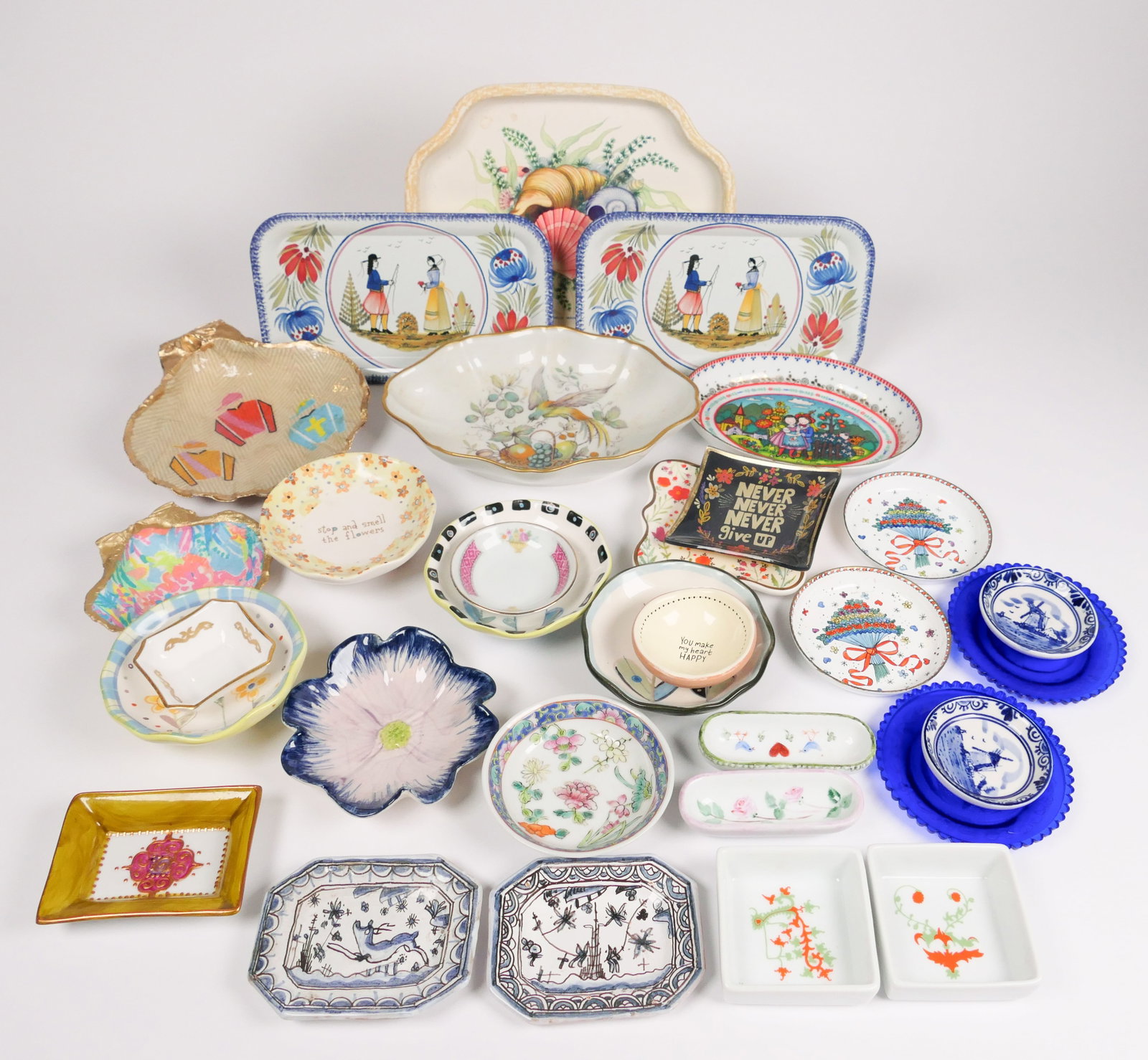 Collection of Small Dishes and Trays: Collection of small dishes and trays including (2) Henriot Quimper tin trays, (2) mini windmill dishes, pansy dish, jockey silks shell dish, Chinese porcelain dish and much more. Size: Shell tray