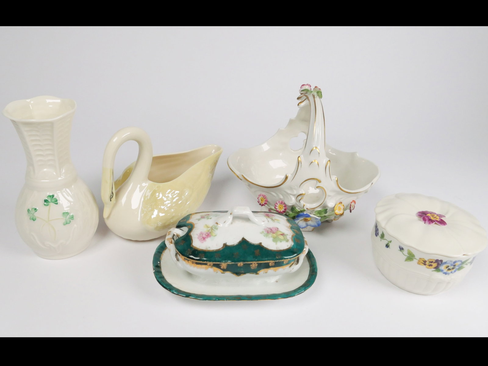 Porcelain Home Accents: Porcelain home accents including (3) Belleek pieces from 1980-1999, Von Schierholz basket and Austrian mini covered tureen. Some discoloration and color loss. Size: Basket 6"w x 4.5"d x 6"h Location: