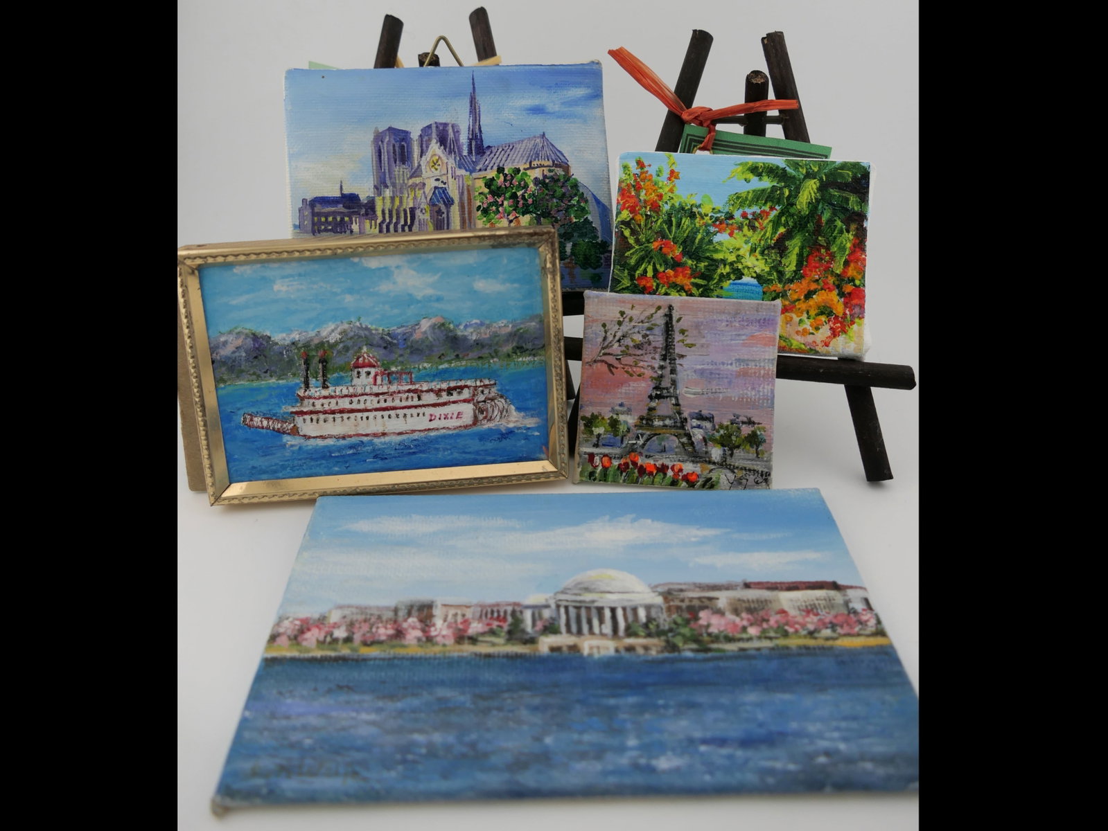 Miniature Travel Art: Miniature travel art acrylic on canvas including Lake Tahoe by M.Micciche, Ann Ridge Kemp and more, (5) pieces of art and some stands. Size: Largest 5"w x 3"h Location: Living Room