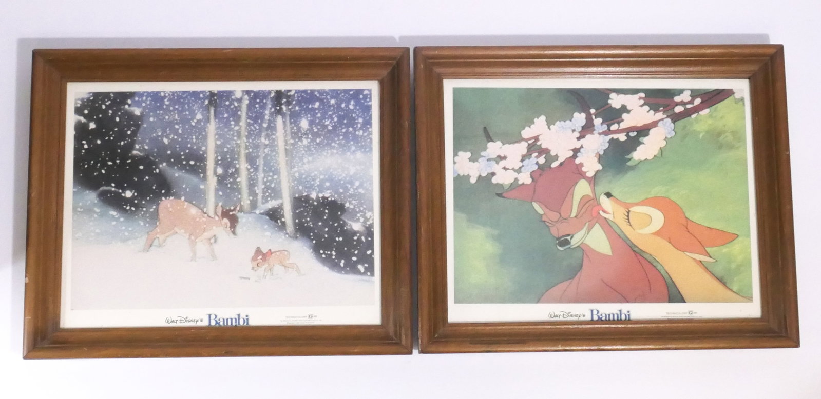 Framed Bambi Theatrical Lobby Cards: Pair of framed Bambi theatrical lobby cards, each depicting scenes from the film. Each in wood frame. Size: 16.25"w x 13.25"h