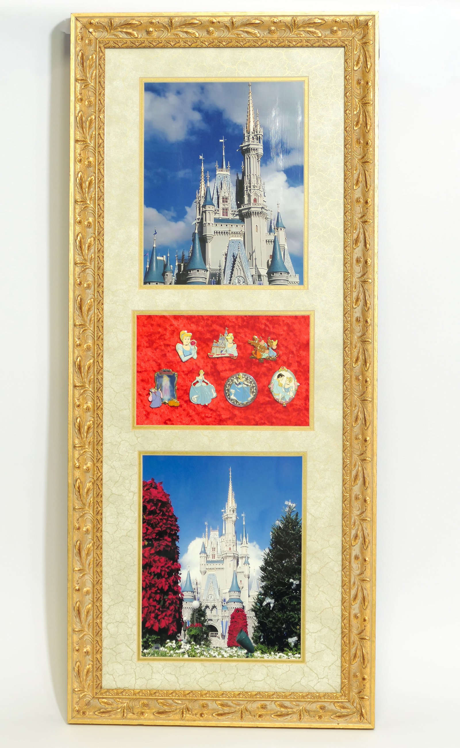Disney Cinderella Pin Collection: Framed display of 7 Disney Cinderella pins(2002-2003) with 2 photographic prints of Cinderella's castle, double-matted in ornate gold tone wood frame. Size: 14.5"w x 33.5"h