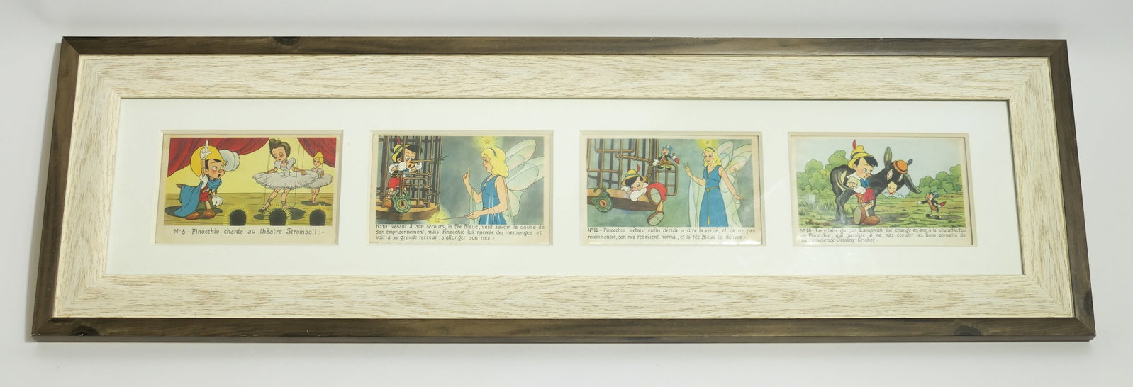 Framed 1940's Walt Disney Pinocchio Superluxe Postcards: Framed display of 4 1940's Walt Disney Pinocchio Superluxe postcards, all single-matted in a two-tone wood frame. Size: Frame 31.5"w x 9.5"h Cards 5.5"w x 3.5"h