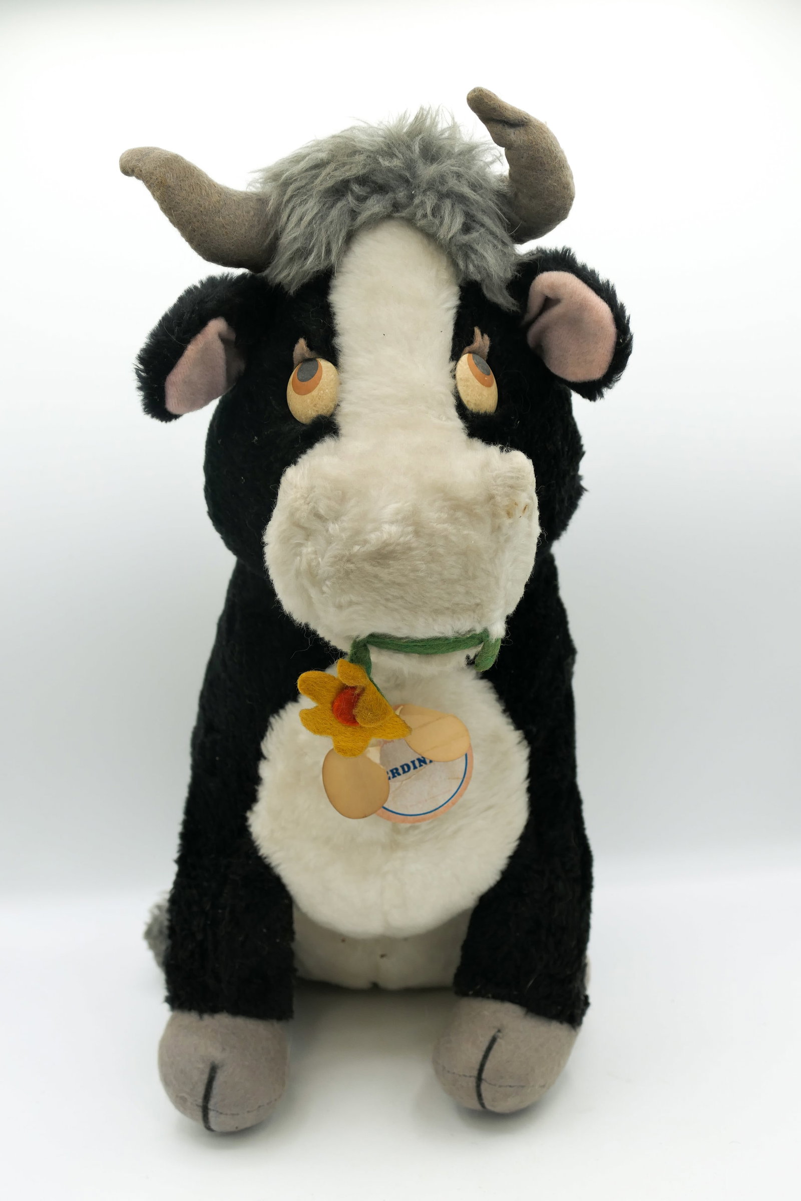 Disney Ferdinand the Bull Plush Toy: Vintage Disneyland exclusive Ferdinand the Bull plush toy with flower in his mouth. Shows wear consistent with age. Disneyland Exclusive paper tag is ripped. Size: 16"h