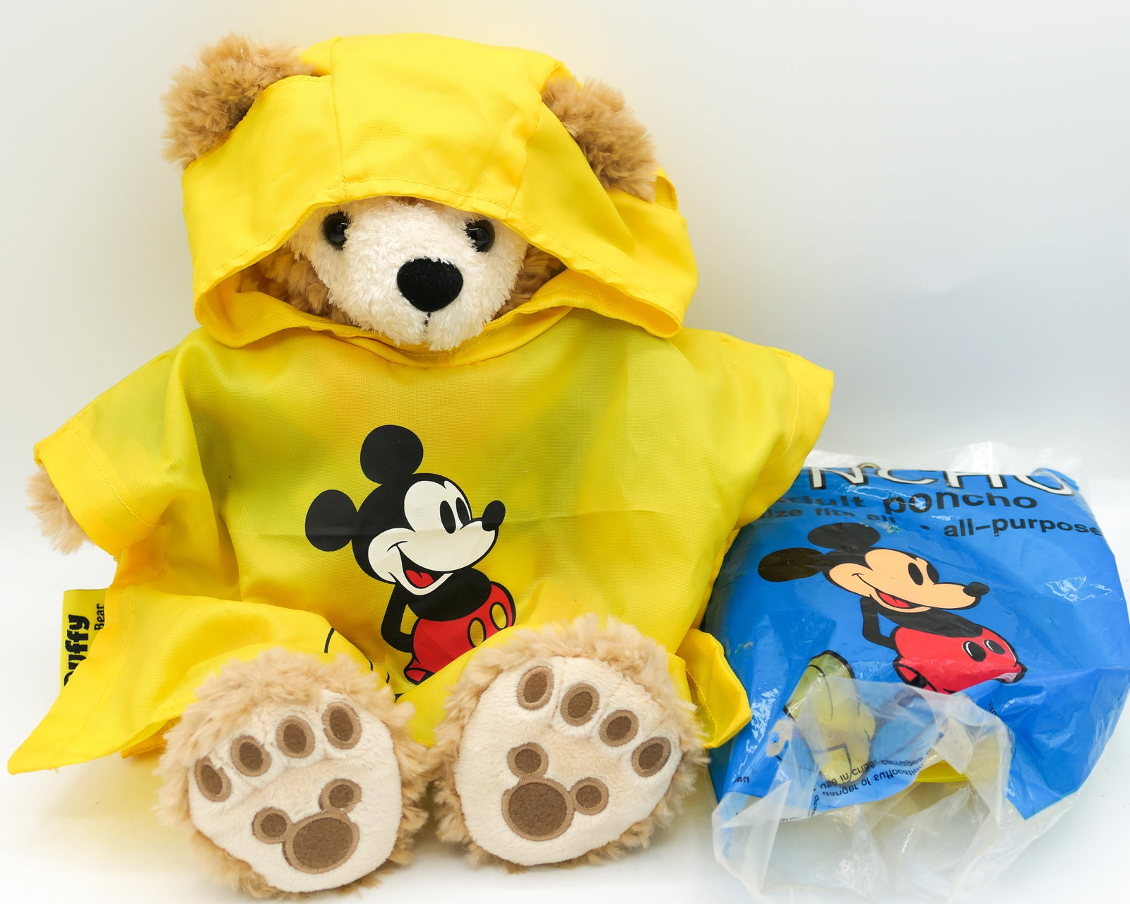 Duffy the Disney Bear Plush Toy: Duffy the Disney Bear Uncle Sam July 4th plush bear with ear tag which includes a story. Also includes a Duffy poncho featuring Mickey Mouse. Missing his hat. Size: 12"h