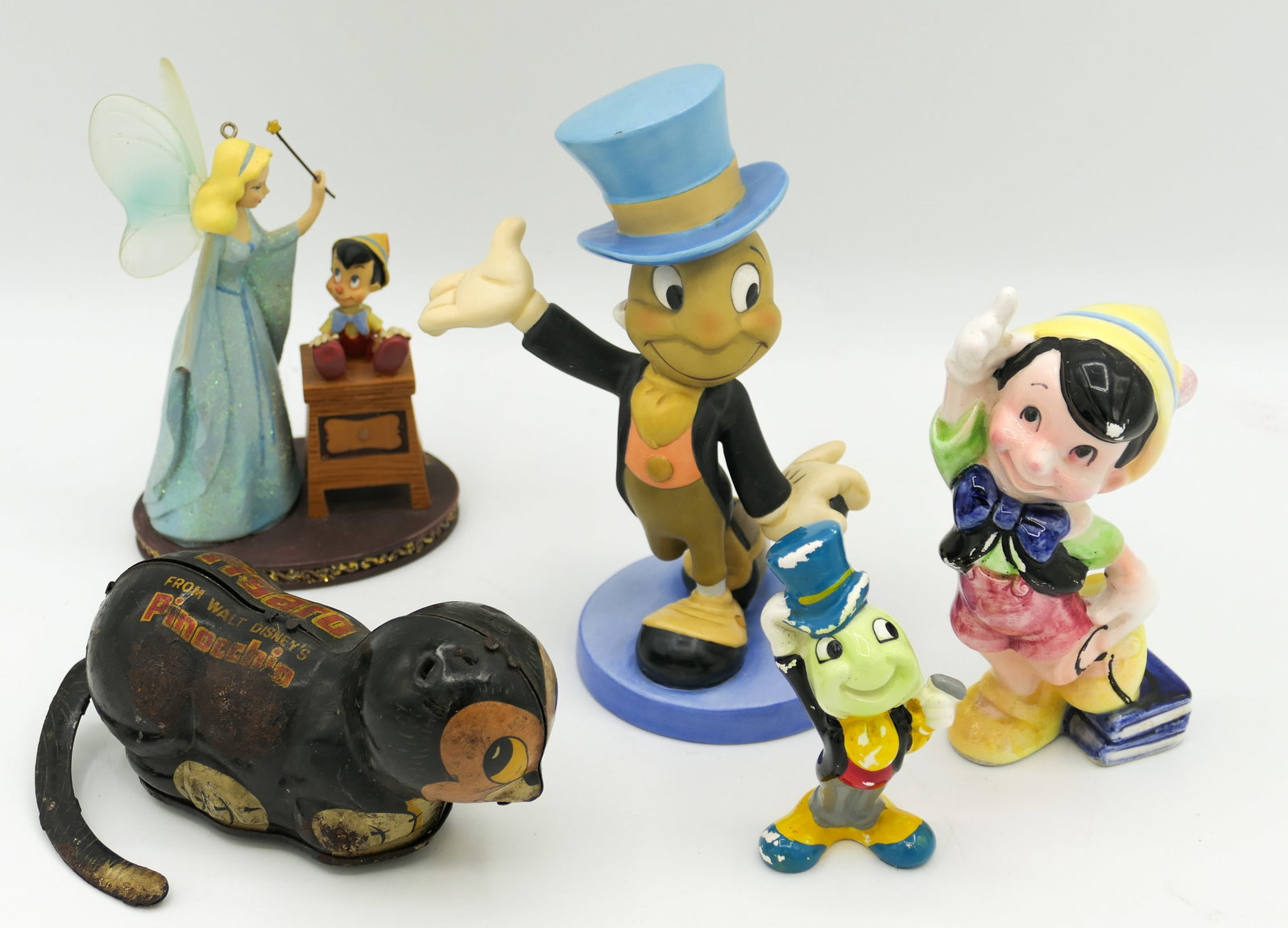 Pinocchio Figurines and Toys: Pinocchio collectibles which includes a 2009 Sketchbook Christmas ornament (blue fairy missing right hand), Walt Disney Productions Japan porcelain Real Boy figurine (some paint loss), Walt Production