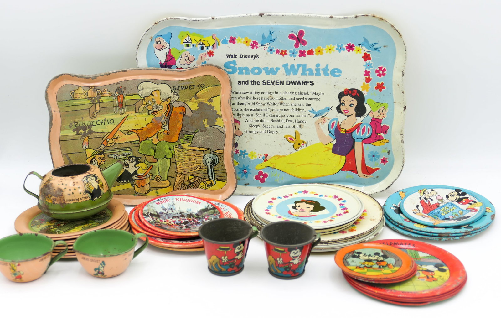 Disney Tin Litho Tea Sets: Vintage Walt Disney tin litho partial tea sets including Walt Disney Productions Goofy and Mickey 3 plates and 2 saucers, 1939 Walt Disney Productions Pinocchio tea set which includes a teapot (no