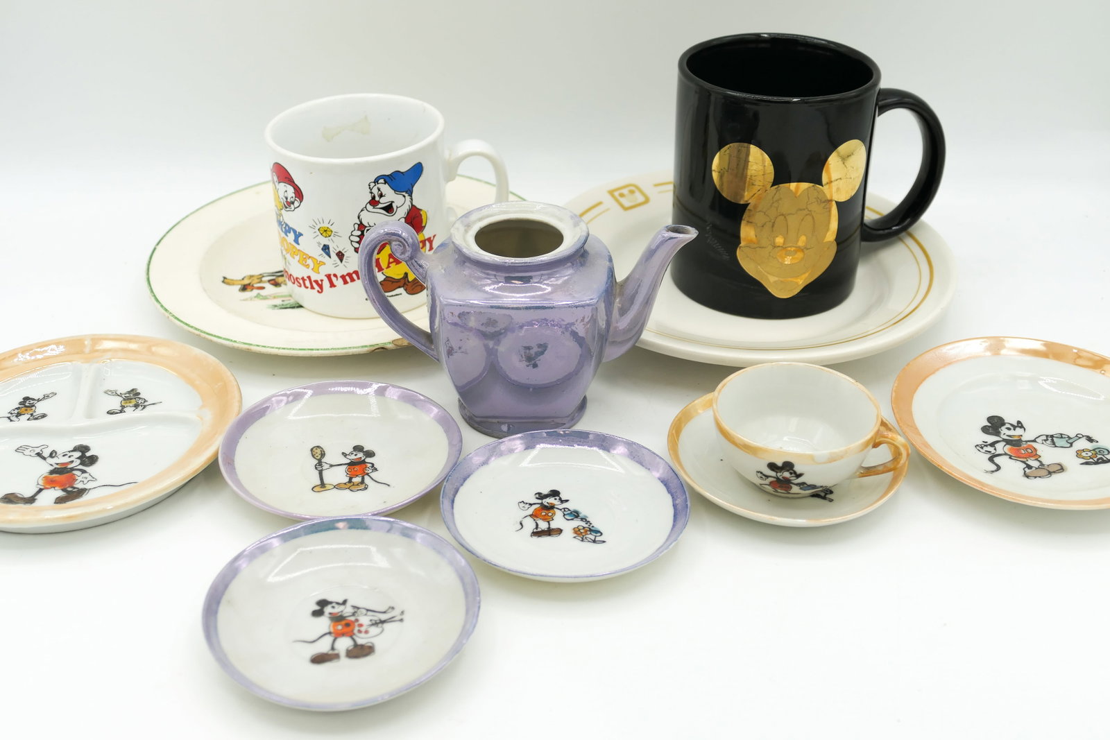 Disney Themed China: Disney themed china pieces including partial lusterware Mickey Mouse tea set, 1930's Patriot China Mickey and Friends plate (chips and color loss), Buffalo by Oneida plate with Disney symbol and more