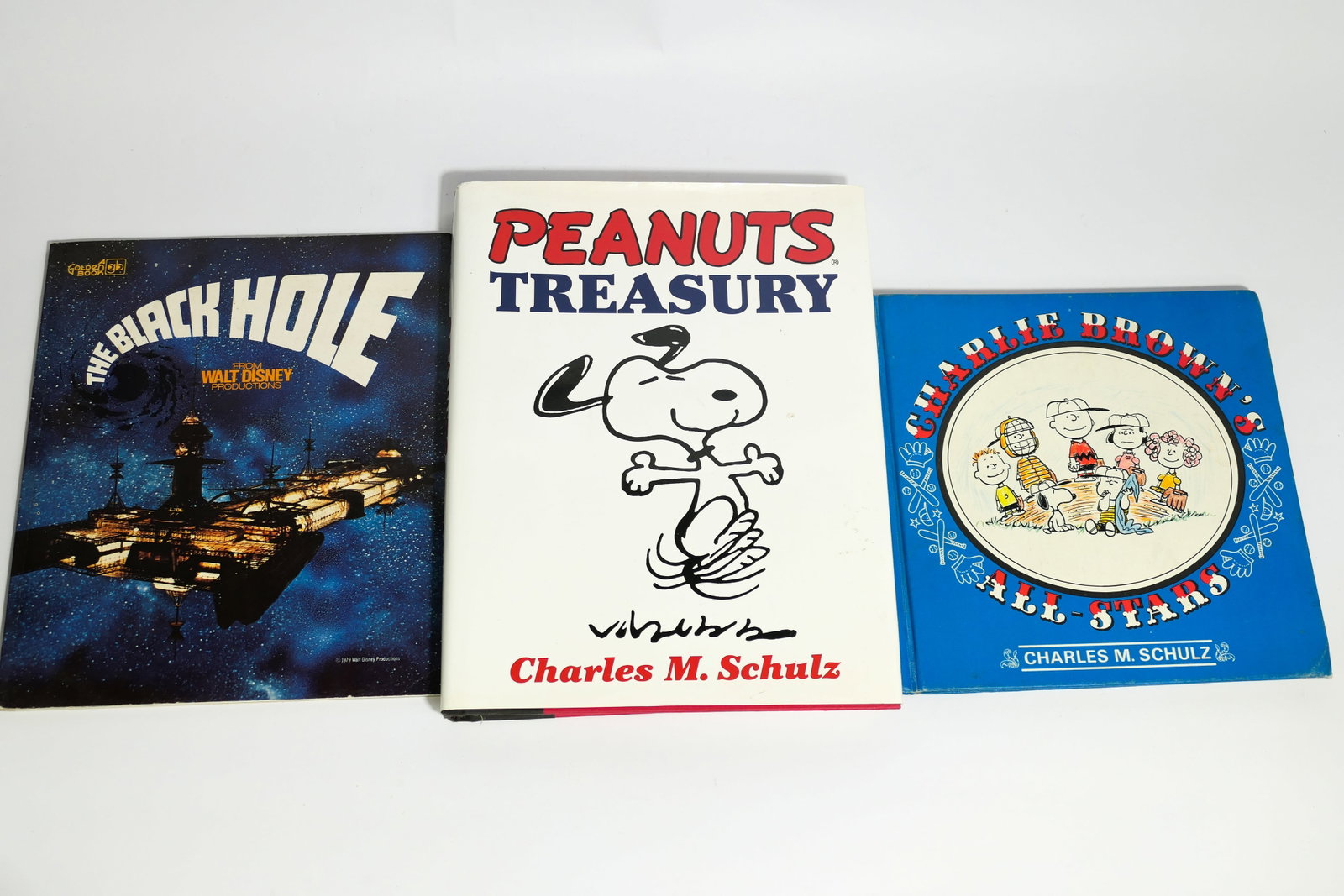Three Books: Three books including 1966 hardcover first edition "Charlie Brown's All-Stars", 1979 "The Black Hole" softcover book and 2000 hardcover "Peanuts Treasury". Charlie Brown and Peanuts books both have