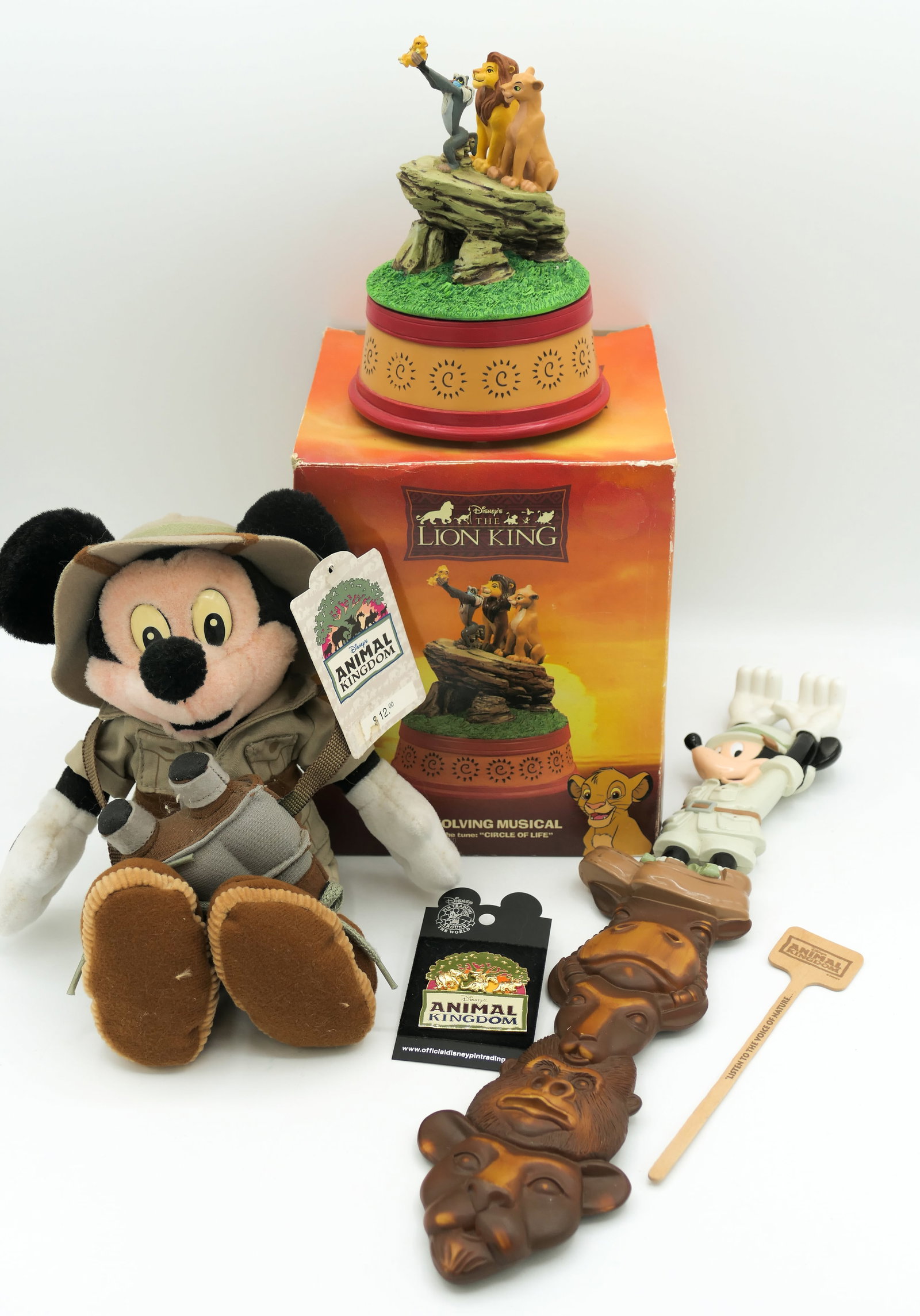 Disney Animal Kingdom Memorabilia: Disney Animal Kingdom memorabilia including a Safari Mickey plush figure, 2003 Animal Kingdom trading pin, 1994 Enesco Lion King music box that spins and plays Circle of Life and a Safari Mickey