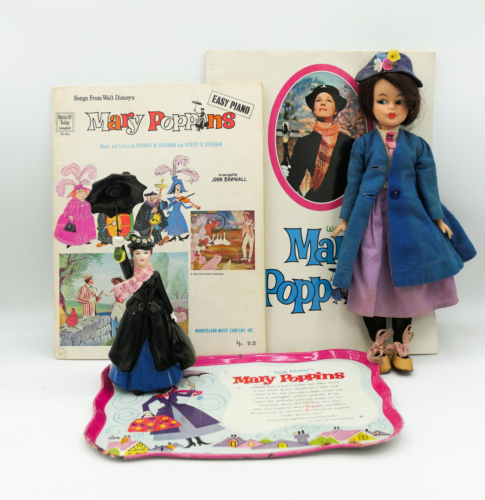 Disney Mary Poppins Collectibles: Disney Mary Poppins collectibles which includes a 1960's Disney Mary Poppins doll by Horsman, Walt Disney Productions Japan porcelain figurine, 1964 Chein U.S.A. tin litho tray, 1965 softcover Mary Po