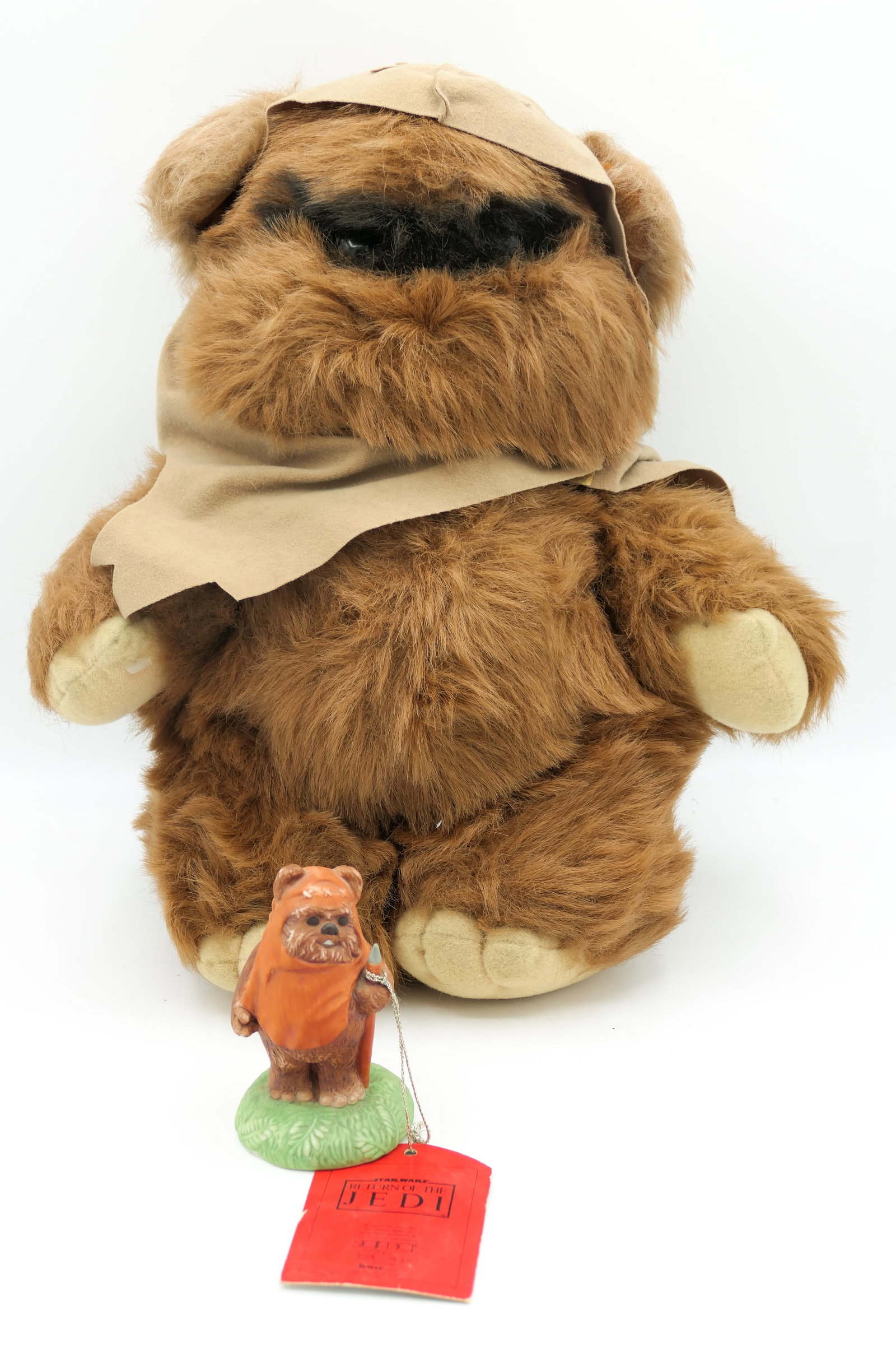 Star Wars Ewok Collectibles: Star Wars Ewok collectibles including a Kenner Wicket the Ewok plush toy and a small ceramic Wicket the Ewok figurine by Sigma the Tastesetter. Figurine shows some finish loss. Size: Plush 14.5"l