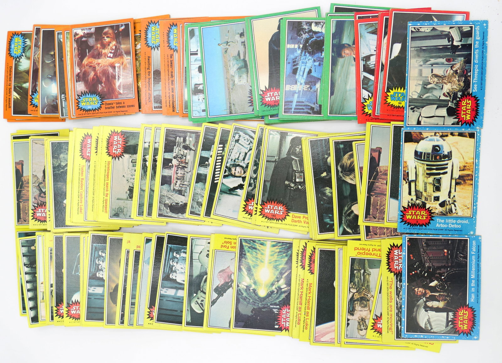 Topps Star Wars Trading Cards: 1977 Topps Star Wars trading cards including yellow, orange, green, blue and red with majority being yellow. There are some duplicates.