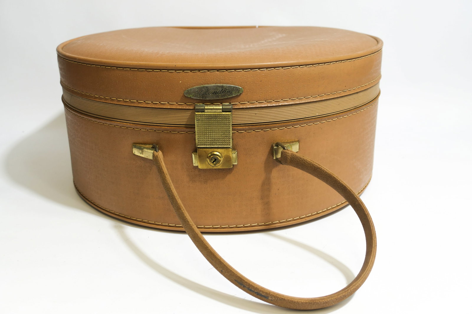 Vintage Blandon Travel Case: Vintage round travel case, marked Blandon. Featuring a satin lining, and gold tone hardware. Wear is present from use. Size: 7"dia x 7.25"h