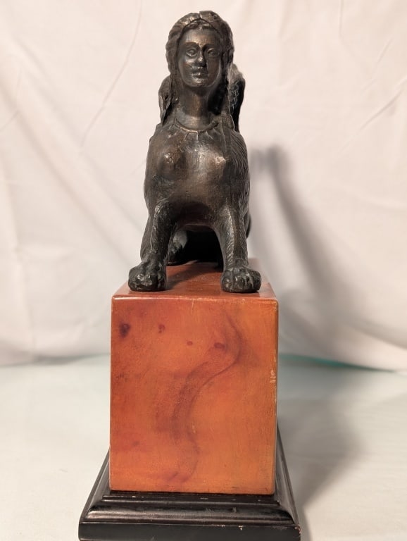 Sphinx - Bronze, Marble/Wood Base: Sphinx - Bronze on Marble and Wood Base. Primitive. Simple style, Patinated. Wear from age. Meas. 9 3/4"h x 8 1/2"w x 4"d. Nice piece.
