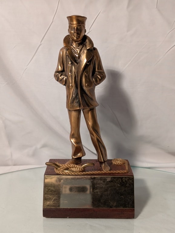 The Lone Sailor - Bronze Statue US Naval Memorial: The Lone Sailor - Bronze Statue US Naval Memorial, Washington D.C. Bronze plaque is blank. Wooden base. Made in USA. No markings. Some wear on base. Nicely patinated. Meas. 9 3/4"h x 4 1/2"w x 3 1/4"d