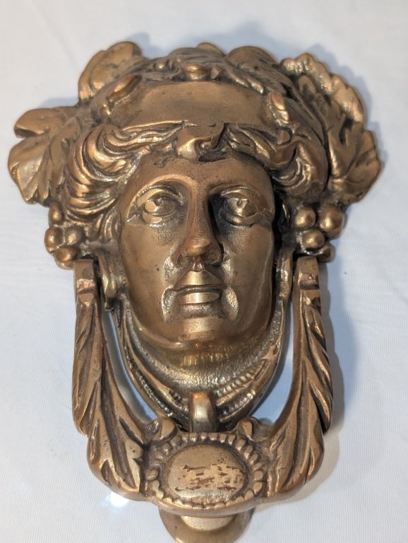 Greek God Dionysus Door Knocker - Cast Brass: Greek God Dionysus Door Knocker - Cast Brass. Depicts Dionysus bust (Greek God of Wine, Fertility, Theatre) with headband and necklace medallion. Medallion and headband are blank and can be engraved.