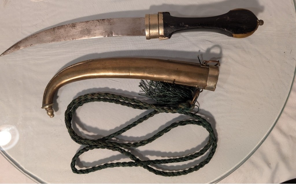 19th c. Arabian Knife w/ Scabboard, Rope - Jambiya: 19th c. Arabian Knife w/ Scabboard, Rope - Jambiya. 3 pieces. All show wear due to use and age. Curved blade tip, wood handle. Brass accents. Brass scabbard. Meas 15" x 1 1/4' x 3/4". 