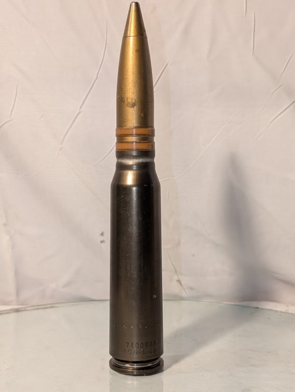 Brass 33mm Missile Shell - Dummy Round: Brass Tip Missile Shell - Dummy Round. Marked Dummy w/ model and serial numbers. Marked 1-03-78. Nicely patinated. Meas. 11 1/2"h x 1 3/4"r; Vietnam / Cold War era.