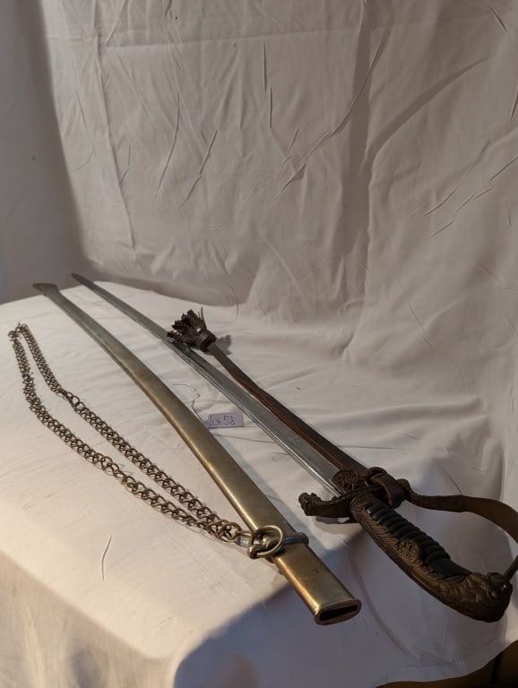 1939-1945 Bulgarian Field Marshall Sword: 1939-1945 Bulgarian Field Marshall Sword w/ Scabboard. Eickhorn. Sword has leather strap w/ tassel. Ornate brass handle. Detailed scroll work on blade. Pommel is a lions head. Very nice