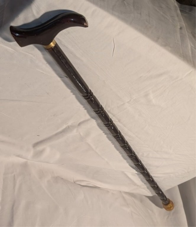 Vintage Wooden Cane w/ Brass Ring Accent: Vintage Wooden Cane w/ Brass Ring Accent. Rubber stopper added later. Black varnish on wood. Meas. 35"l x 5"w x 3/4"d.