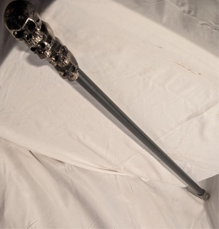 Vtg Walking Cane w/ Skull Chrome Handle: Vtg Walking Cane w/ Stacked Skull Chrome Handle. Gothic style. Black metal shaft. Chrome design at base. Ornate w/ intricate detail. Meas. 381/4"l x 2"w x 2"d.