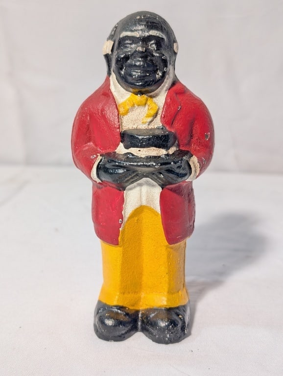 Black Americana - Uncle Moses CI Coin Bank: Black Americana - Uncle Moses Cast Iron Coin Bank. Meas. 5 1/4"h x 1 1/2"w x 1 3/4"d. Some paint loss from age. Original back screw in tact. Overall very nice.