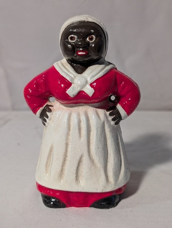 Black Americana - Mammy CI Coin Bank: Black Americana -Mammy Cast Iron Coin Bank. Meas. 5 1/2"h x 3"w x 2 1/2"d. Some paint loss from age. Original back screw in tact. Overall very nice.
