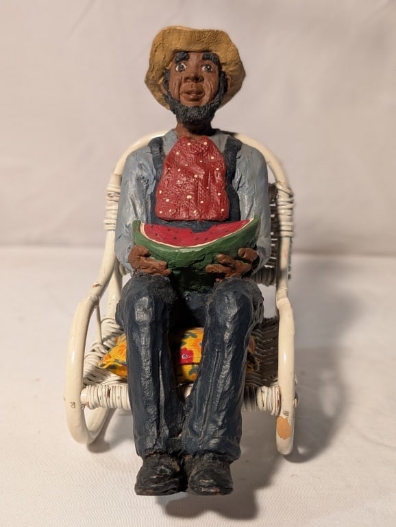 Black Americana - Man In Wicker Chair C. Carpin: Black Americana - Man Eating Watermelon sitting in wicker rocking chair. Rocking chair has cushion Carolyn Carpin, The Story Book Collection. Resin. Meas. 7"h x 4"w x 7"d. Very nice piece.