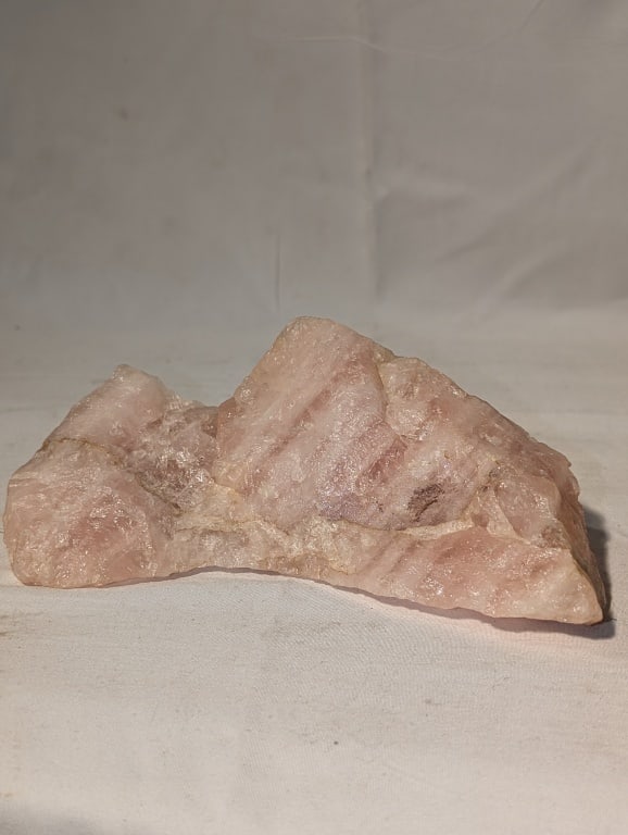 Rose Quartz Stone: Rose Quartz Stone. Mountain shape. Meas. 7" x 2 1/2" x 1 1/2".
