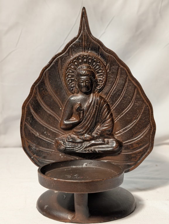 Buddha on a Bodhi Leaf Candle Holder - Bronze: Buddha on a Bodhi Leaf Candle Holder - Bronze statue. Meas. 9 1/2"h x 6 1/4"w x 6"l. Round base. Nice piece