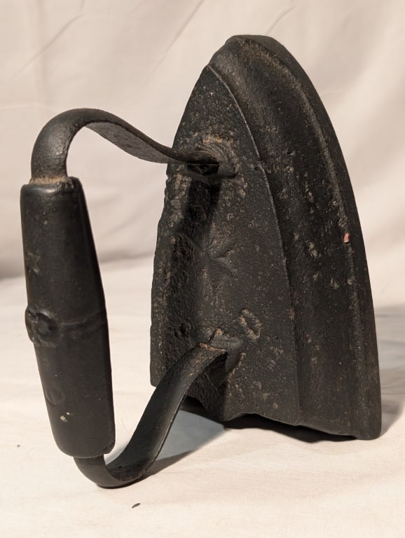 Antique Sadiron - CI w/ Wooden Handle: Antique Sadiron - CI w/ Black Wooden Handle. Black patina. Meas. 6 1/2"h x 4 1/4"w x 5 1/4"d. Shows some pitting and wear.