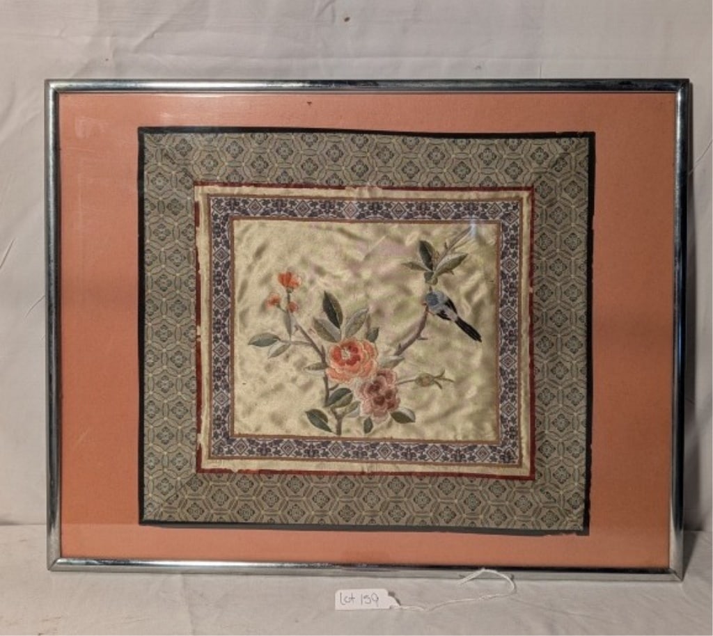 Chinese Embroidered Silk Panel - Framed: Chinese Embroidered Silk Panel - Framed. Depicting peony style flowers. Surrounded by various border designs. Chrome frame. Meas. 18"w x 14"h. Has only 1 hanging ring but hole is drilled for