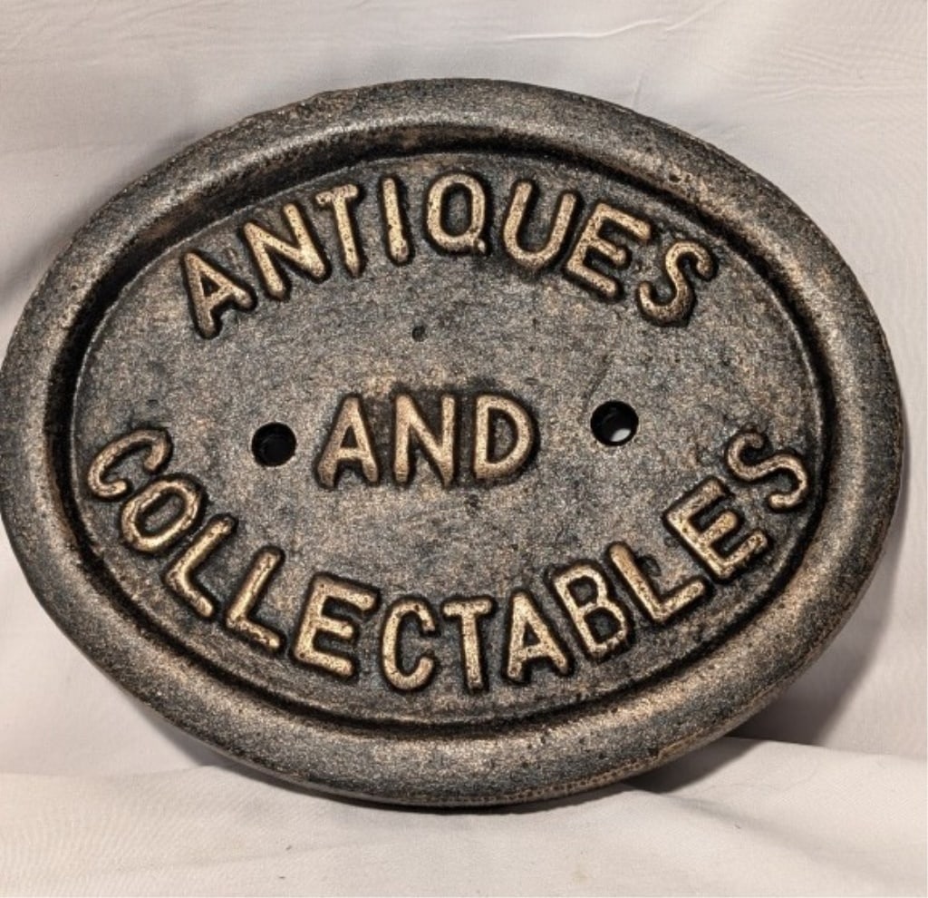 Cast Iron "Antiques & Collectibles' Oval Sign: Cast Iron "Antiques & Collectibles' Oval Sign w/ gilded lettering, holes for hanging. Meas. 6'h x 7 1/4"w x 1/2"d. Nice patina.