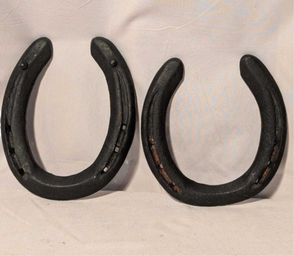 Antique Horseshoes (Pair) Cast Iron: Antique Horseshoes (Pair) Cast Iron. No markings. Nail holes. Shows minor wear, some rust. Grooves on rear of each. One meas. 4 3/4"h x 4 1/2"w. The other meas. 5"h x 4 3/4"w.