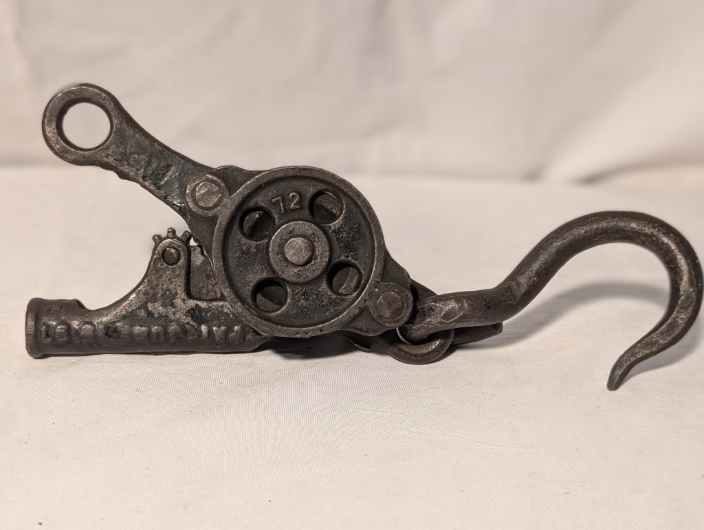 Antique Cast Iron Pulley / Hay Carrier - Ratchet: Antique Cast Iron Pulley / Hay Carrier - Ratchet w/ Hook. Marked 72. Meas. 3 3/4"h x . 9 3/4"w x 2"d