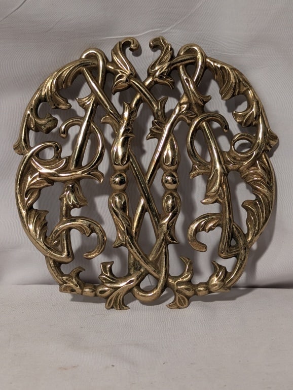 Brass Trivet - T. Jefferson Cipher CW-10-14: Copyright 1950 Brass Trivet - Thomas Jefferson Cipher Colonial Willisburg, VA. CW-10-14,marked on reverse. VA Metalcrafters. Meas. 6"h x 6"w x 1/2"d.