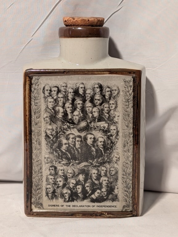 Maple Syrup Bottle Decl / Independence Signers: Maple Syrup Bottle depicting the Signers of the Declaration of Independence. Japanese Porcelain w/ in tact cork. Raised relief 1776 on sides. Meas. 7 3/4"h x 4 3/4"w x 2 2'd.