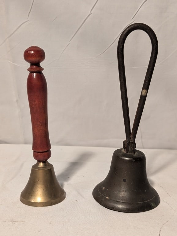 Antique Bell Collection, Brass & Cast Iron (2): Antique Bell Collection, Cast iron bell w/ looped handle, all original, clapper in tact. Nicely patinated, show wear. The other is a brass and wooden handled dinner bell. Loop handle meas. 7 1/4"
