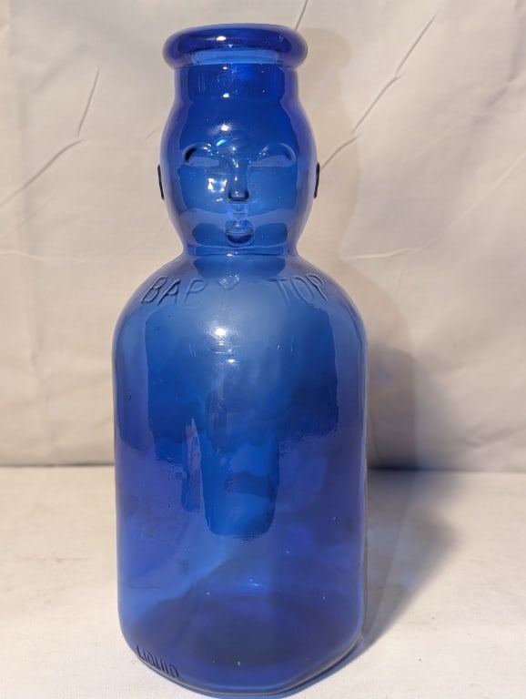 Brookfield Blue Baby Top Glass Milk Bottle: Brookfield Cobalt Blue Baby Top Glass Milk Bottle w/ face in raised relief. No cork. 1 qt liquid. Meas. 9 1/2"h x 3 1/2"w.