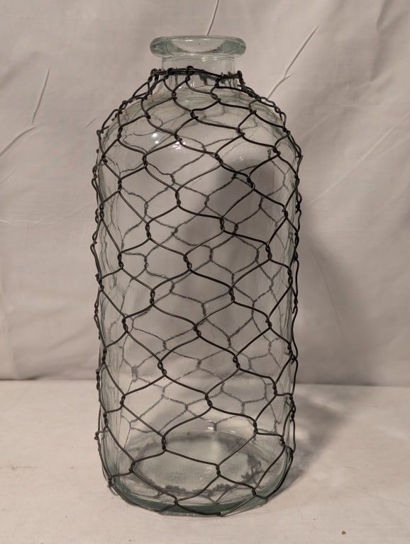 Clear Milk Bottle Encapsulated in Chicken Wire: Clear Milk Bottle Encapsulated in Chicken Wire. No chips. Meas. 10"h x 4 1/2"r.