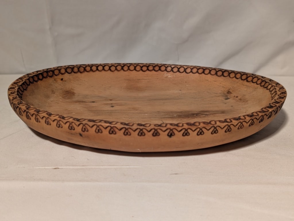 Columbia Hand Carved Wooden Bowl, Wood Burned Edge: Vintage Columbia Hand Carved Wooden Bowl, Wood Burned Hart and Circle Edge. Bowl is shallow. Used as a dough bowl or trencher. Shows some discoloration due to use. Logo burned on bottom. Meas.