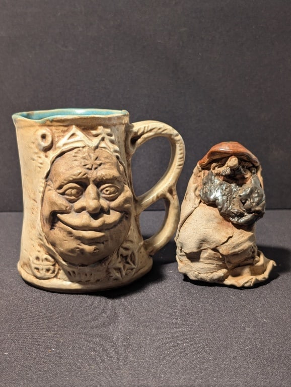 1970s Clay Troll Tankard Jim Rumph & Troll Statue: 1970s Clay Troll Tankard Jim Rumph & Troll Statue. Handmade clay tankard has 3D face, a demon on the reverse side, dragon / serpent tail handle and an interior gremlin. Meas. 5"h x 5"w x 4 1/2"d. Hand