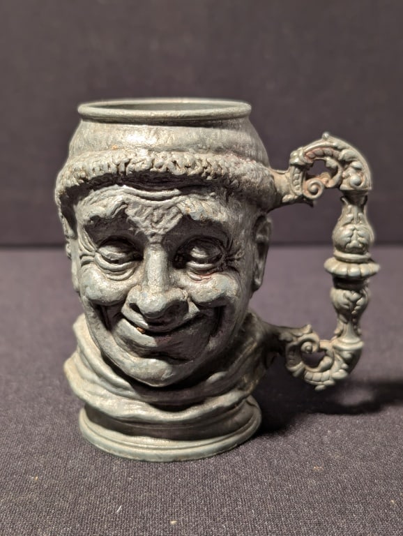 Miniature Pewter Toby Jug: Miniature Pewter Toby Jug. with smiling face and ornate handle. Meas. 3 1/2"h x 3"w x 2 1/4"d
