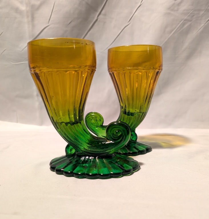 Jeanette Glass Co - Cornucopia Glasses - Pair: Jeanette Glass Co - Cornucopia Glasses - Pair, Has amber trumpet ribbed top flowing into green curled tail and base. Bottom has some minor rough edges due to manufacturing. Nice color gradient. Each m