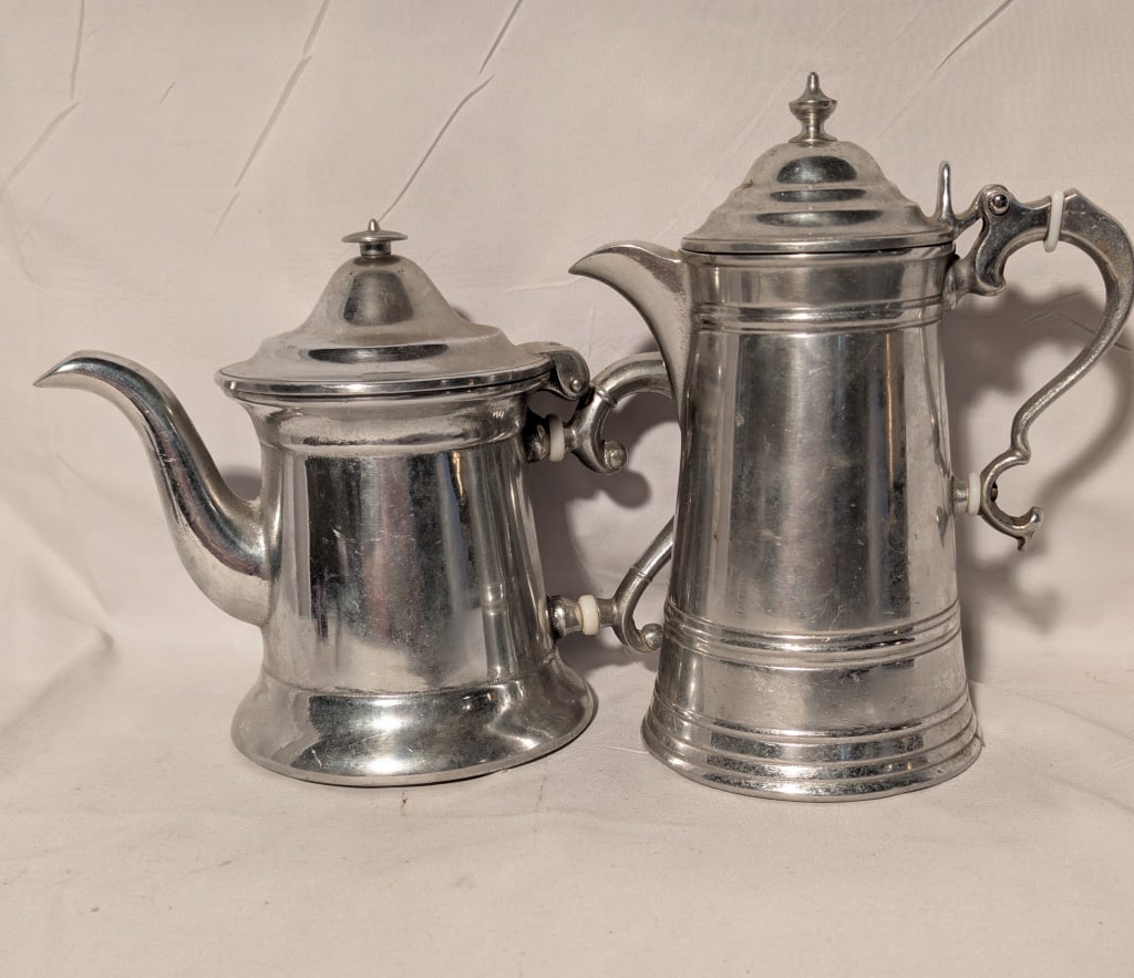 Wilton Pewter Tea and Coffee Pots: Wilton Pewter Tea and Coffee Pots. Coffee pot has some staining on the inside. Coffee pot meas. 8"h x 4"w. x 7:d Teapot meas. 8 1/2"h x 4"w x 7". Both have staining on the inside. Good condition.